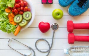 Fresh vegetable salad and green apple with medical stethoscope