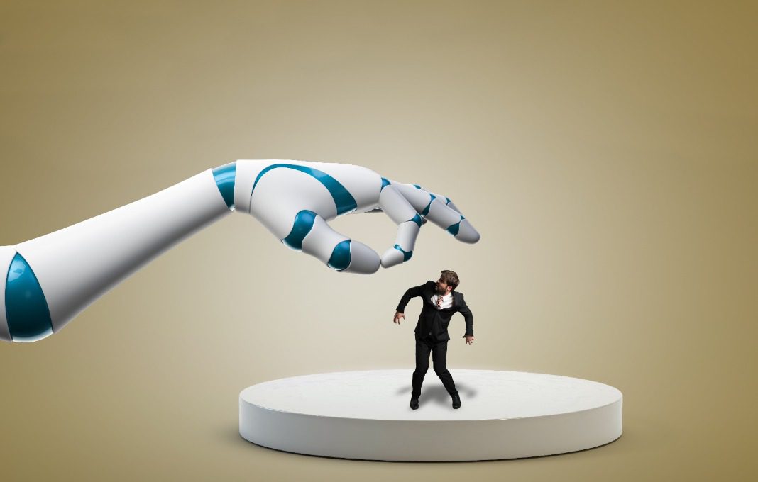 Robot arm moving to pick up employee