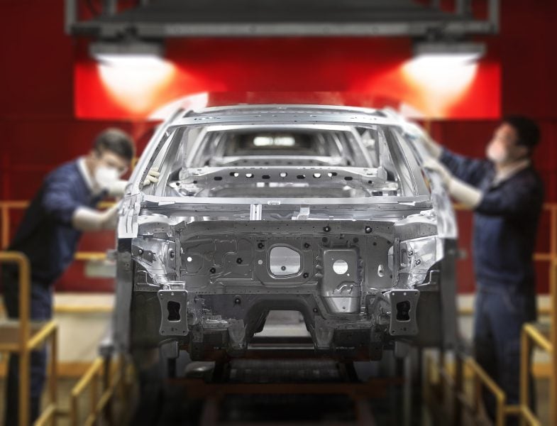 Workers constructing a car.
