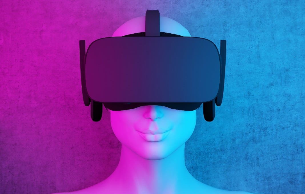 Mannequin head wearing VR headset on purple and blue background