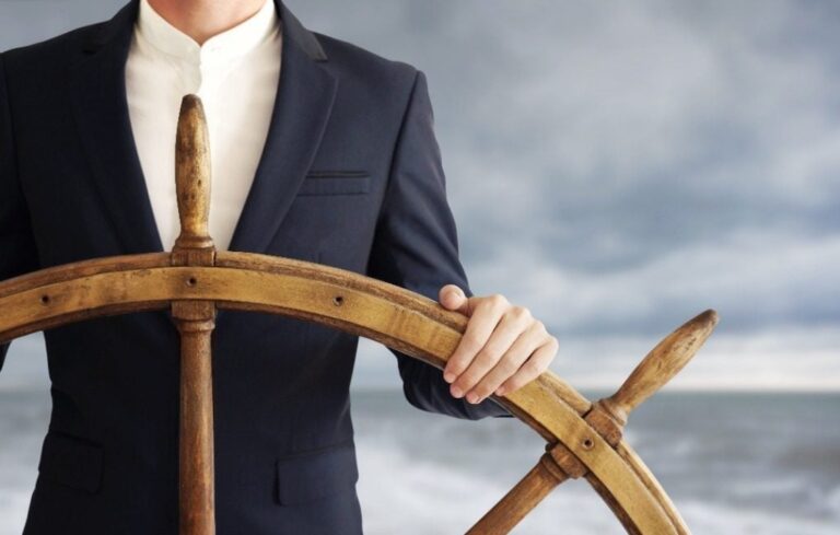 Business man steering boat